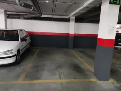 a parking garage with a white car parked in it at Casa Bakio in Sanlúcar de Barrameda