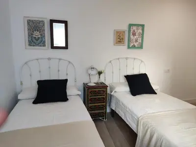 two beds sitting next to each other in a room at Casa Laida in Sanlúcar de Barrameda