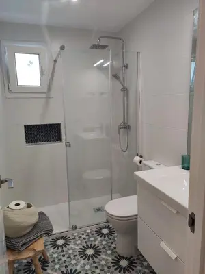 a bathroom with a shower and a toilet and a sink at Casa Laida in Sanlúcar de Barrameda