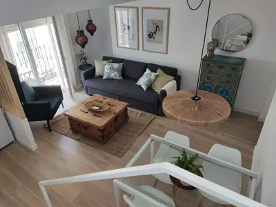 a living room with a couch and a coffee table at Casa Laida in Sanlúcar de Barrameda