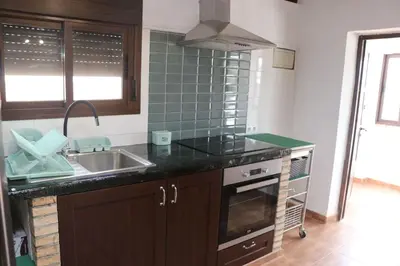 a kitchen with a sink and a counter top at Casa Abuelo Miguel in Conil de la Frontera