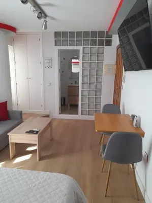 a room with a bed and a table and a couch at Acogedor Apartamento Entero in Arcos de la Frontera