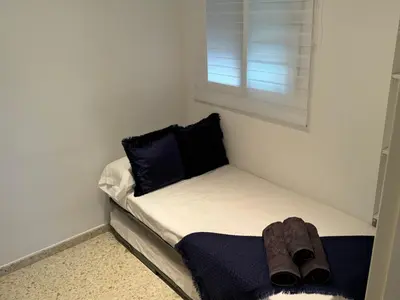 a small bed with a pair of shoes sitting on it at Lola9 in Sanlúcar de Barrameda