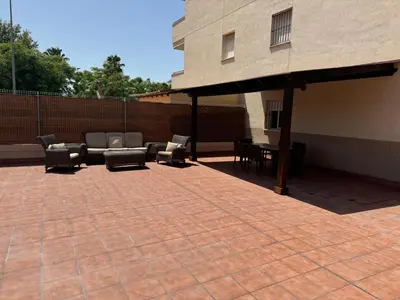 a patio with couches and chairs on a building at Lola9 in Sanlúcar de Barrameda