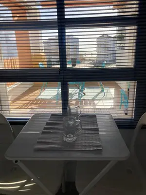 a mug on a table in front of a window at ÁTICO Jardines de la salinera de VALDELAGRANA in El Puerto de Santa María