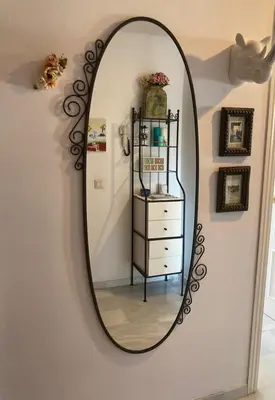 a mirror hanging on a wall with a dresser at ÁTICO Jardines de la salinera de VALDELAGRANA in El Puerto de Santa María