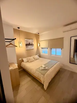 a bedroom with a bed with two towels on it at Casa Moderna in Jerez de la Frontera