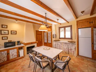 a kitchen with a table and chairs and a refrigerator at Casa Rancho el Marques fjhomefj in Jerez de la Frontera