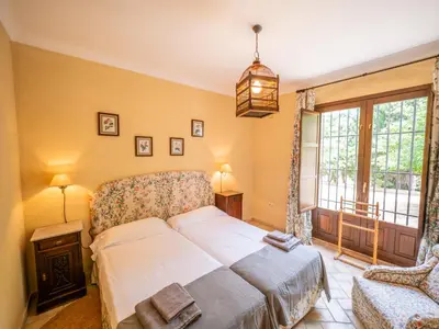a bedroom with a large bed and a window at Casa Rancho el Marques fjhomefj in Jerez de la Frontera