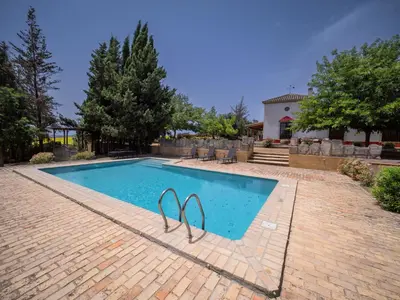 a swimming pool with a pair of swimmingoons in it at Casa Rancho el Marques fjhomefj in Jerez de la Frontera