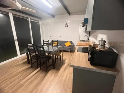 a kitchen and dining room with a table and chairs at Finca Rural Marmito in Sanlúcar de Barrameda