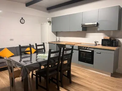 a kitchen with a table and chairs in a room at Finca Rural Marmito in Sanlúcar de Barrameda