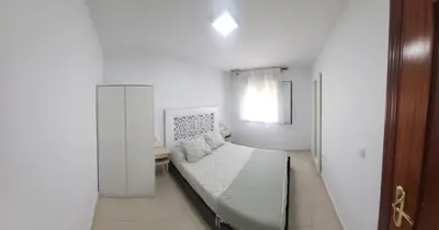 a bedroom with a bed and a window in a room at Casa Andrea in Puerto Real
