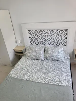 a white bed with two pillows in a bedroom at Casa Andrea in Puerto Real