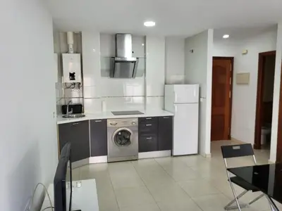 a kitchen with a washing machine and a refrigerator at Casa Andrea in Puerto Real
