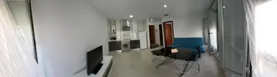 a room with two chairs and a television in it at Casa Andrea in Puerto Real