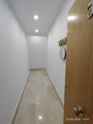 a room with a door and a hallway with white walls at Apartamentos Luxury Play Victoria in Cádiz