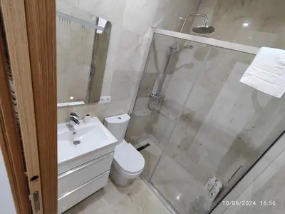 a bathroom with a shower and a toilet and a sink at Apartamentos Luxury Play Victoria in Cádiz