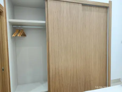 a closet with a wooden door and some baseball bats at Apartamentos Luxury Play Victoria in Cádiz