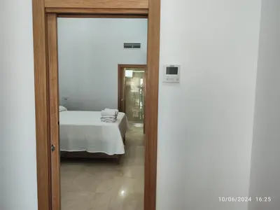 a door leading to a bedroom with a bed at Apartamentos Luxury Play Victoria in Cádiz