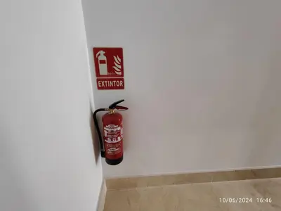 a fire extinguisher sign on the wall of a bathroom at Apartamentos Luxury Play Victoria in Cádiz
