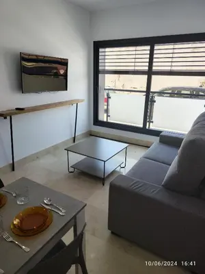 a living room with a couch and a table at Apartamentos Luxury Play Victoria in Cádiz