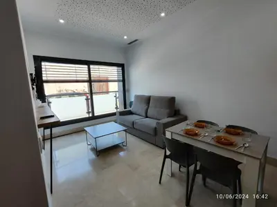 a living room with a couch and a table at Apartamentos Luxury Play Victoria in Cádiz