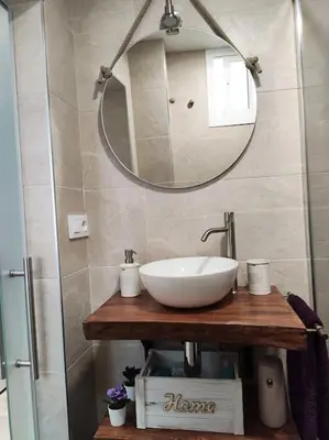 a bathroom with a white sink and a mirror at Apartamento 'Mini Jungle' en el corazón de Cádiz in Cádiz
