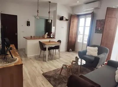 a living room with a couch and a table at Apartamento 'Mini Jungle' en el corazón de Cádiz in Cádiz