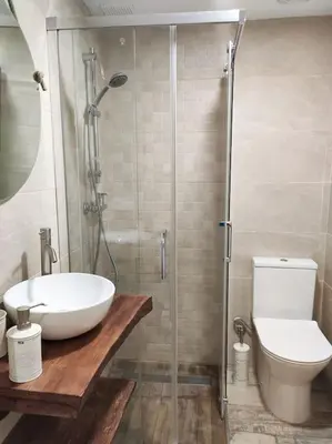 a bathroom with a shower and a sink and a toilet at Apartamento 'Mini Jungle' en el corazón de Cádiz in Cádiz