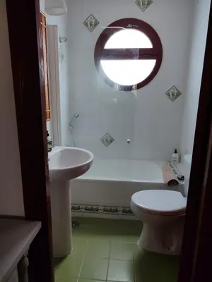 a bathroom with a sink and a tub and a toilet at Chalet Roche a 300 metros de la playa in Roche