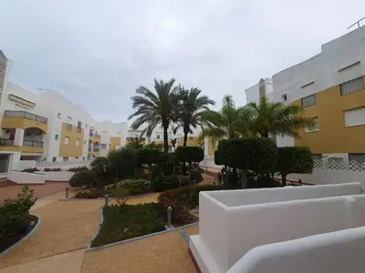 a view of a courtyard with palm trees and buildings at Bogavante Costa Ballena in Rota