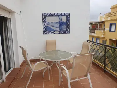 a balcony with a table and chairs on it at Bogavante Costa Ballena in Rota