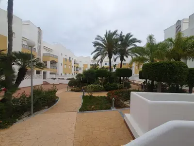 a view of a courtyard with palm trees and buildings at Bogavante Costa Ballena in Rota