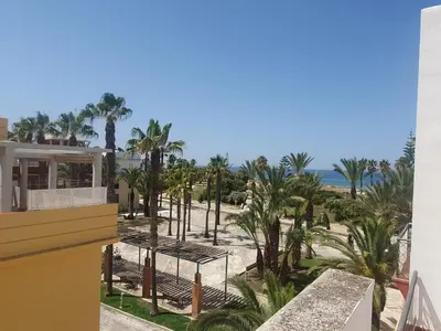 a view of the beach from the balcony of a resort at Bogavante Costa Ballena in Rota