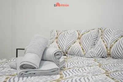 a pile of towels and towels on a bed at El Anfitrión - Argüeso 8 in Sanlúcar de Barrameda
