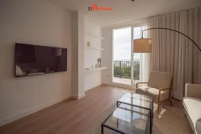 a living room with a couch and a table at El Anfitrión - Mirador en casco antiguo con parking in Sanlúcar de Barrameda
