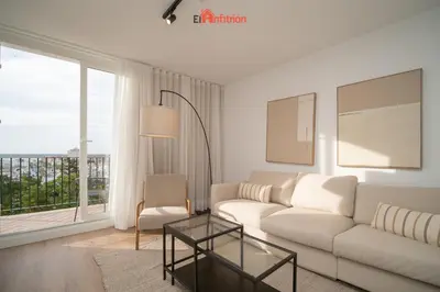 a living room with a white couch and a glass table at El Anfitrión - Mirador en casco antiguo con parking in Sanlúcar de Barrameda
