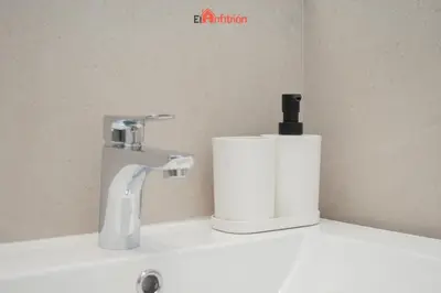 a bathroom sink with a faucet and a soap dispenser at El Anfitrión - Mirador en casco antiguo con parking in Sanlúcar de Barrameda