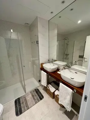 a bathroom with two sinks and a shower at Costa Ballena & Eleven Lights in Chipiona