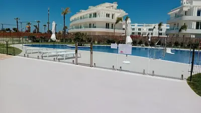 a swimming pool in front of a building at Costa Ballena & Eleven Lights in Chipiona