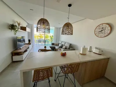 a kitchen and living room with a table and chairs at Costa Ballena & Eleven Lights in Chipiona