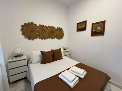 a bedroom with a bed with two towels on it at Rodmar Playa Grupo AC Gestion in Cádiz