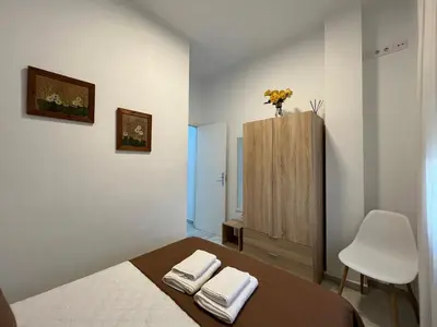 a bedroom with a bed and a chair and a cabinet at Rodmar Playa Grupo AC Gestion in Cádiz