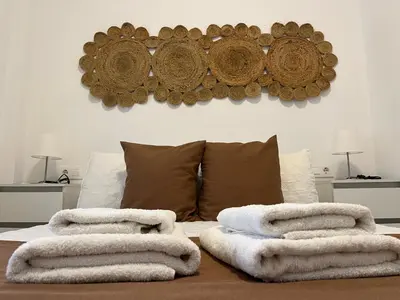 a pile of towels sitting on top of a bed at Rodmar Playa Grupo AC Gestion in Cádiz