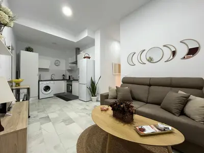 a living room with a couch and a table at Rodmar Playa Grupo AC Gestion in Cádiz