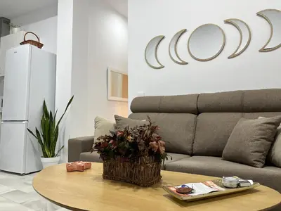 a living room with a couch and a table at Rodmar Playa Grupo AC Gestion in Cádiz
