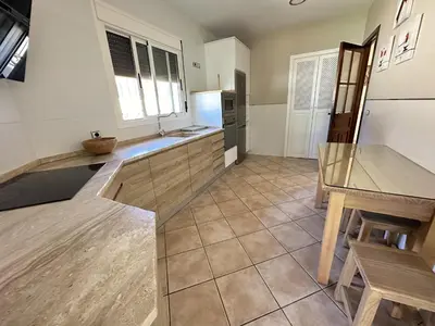 a kitchen with a table and a counter top at Apartamentos Chiclana Chalet Carboneros in Chiclana de la Frontera