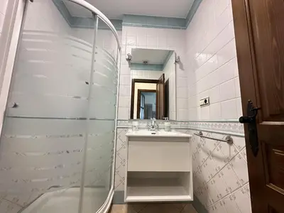 a bathroom with a shower and a sink and a mirror at Apartamentos Chiclana Chalet Carboneros in Chiclana de la Frontera