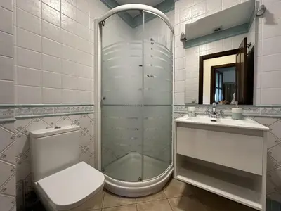a bathroom with a shower and a toilet and a sink at Apartamentos Chiclana Chalet Carboneros in Chiclana de la Frontera